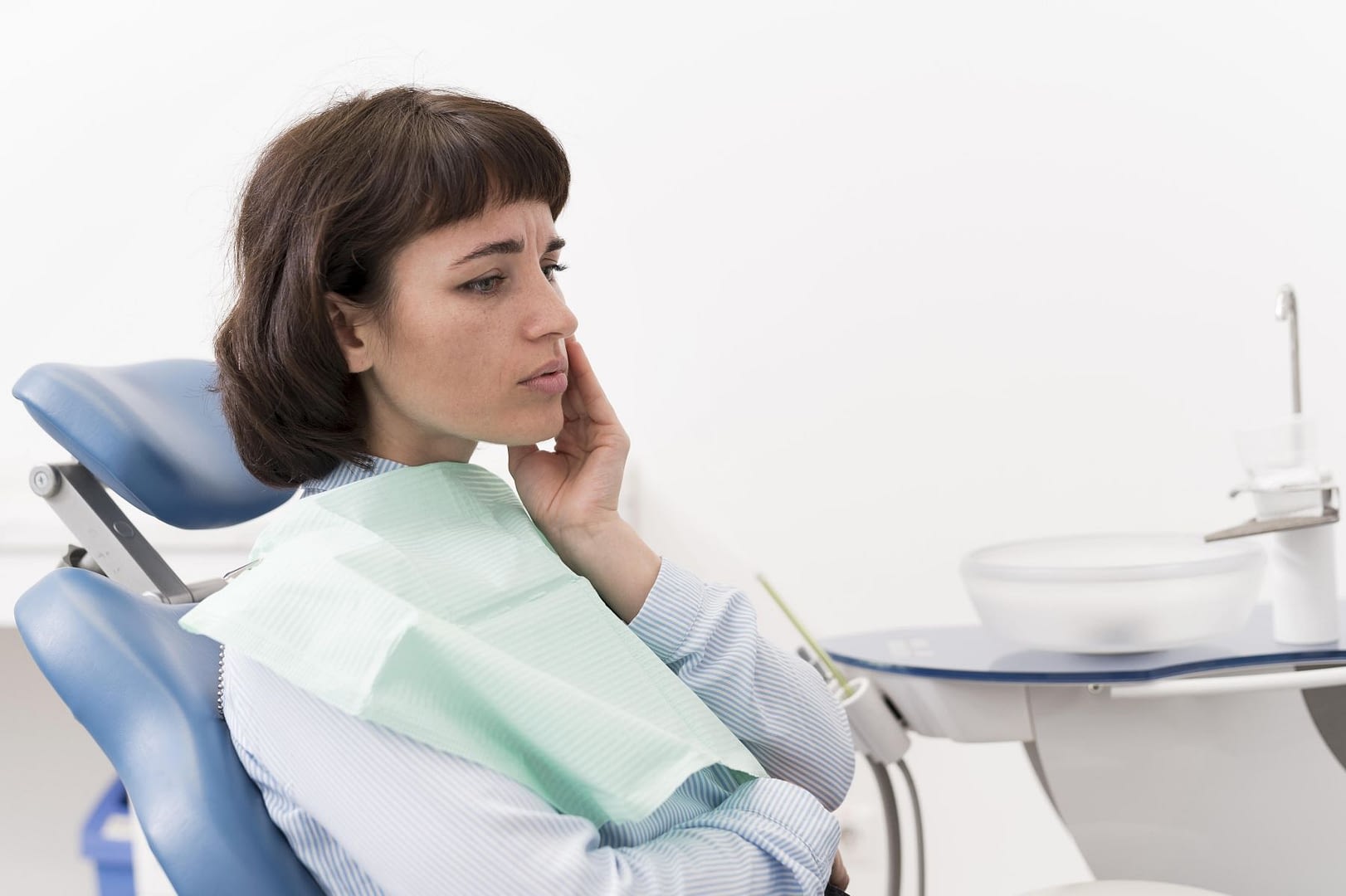 female patient having toothache dentist s office