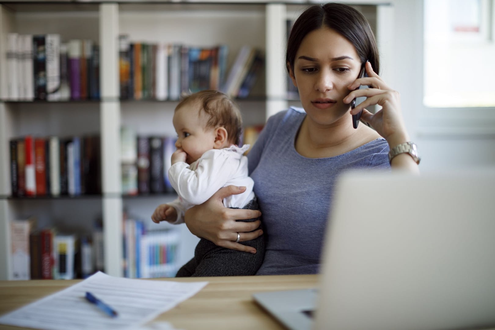 worried mother using mobile phone an laptop at home Claim What’s Yours
